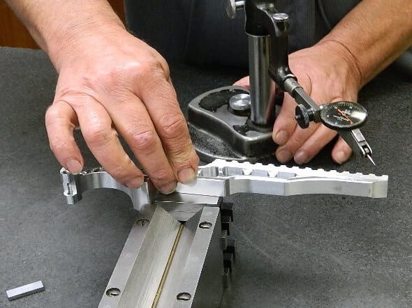 A person using a pair of scissors to cut metal.
