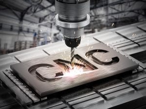 A machine cutting metal with the word cnc