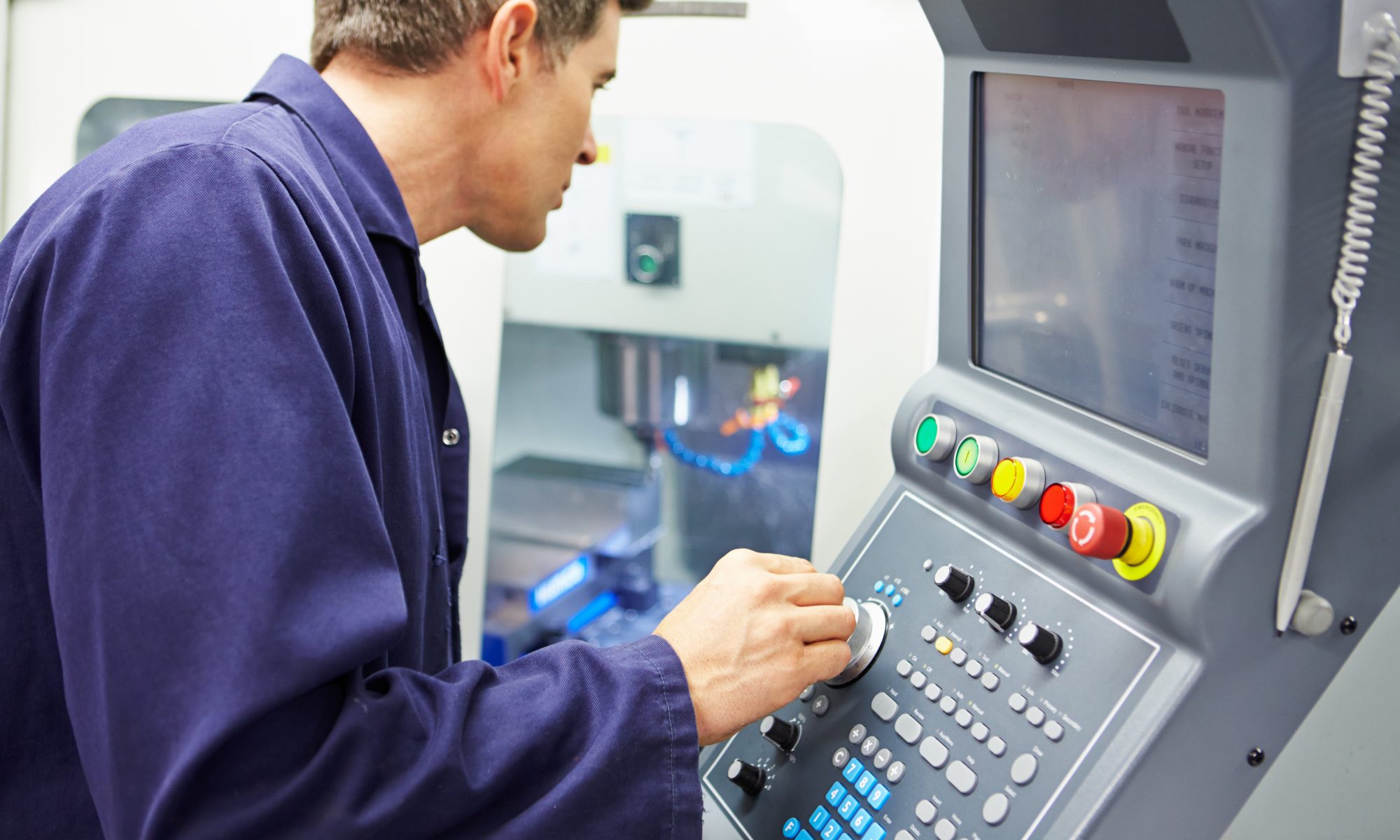 A man operating a machine in a factory.