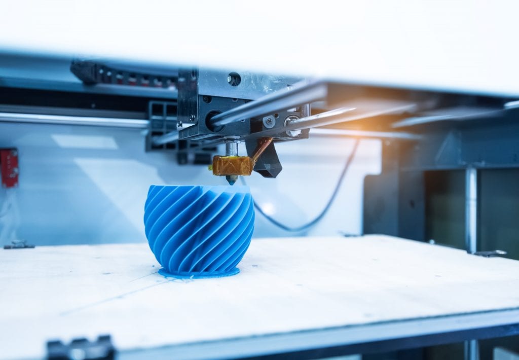 3D printer printing blue wavy shaped part